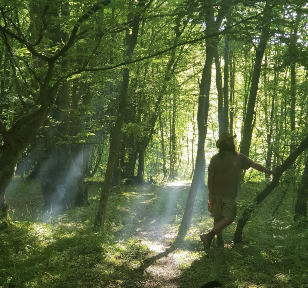 Chris standing in the forest.